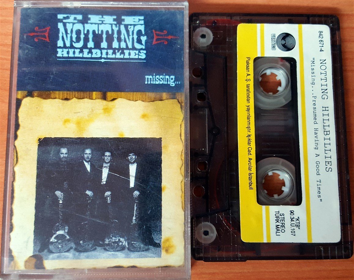 NOTTING HILLBILLIES - MISSING...PRESUMED HAVING A GOOD TIME (1990) PLAKSAN CASSETTE MADE IN TURKEY ''USED'' PAPER LABEL (PRODUCED BY MARK KNOPFLER)