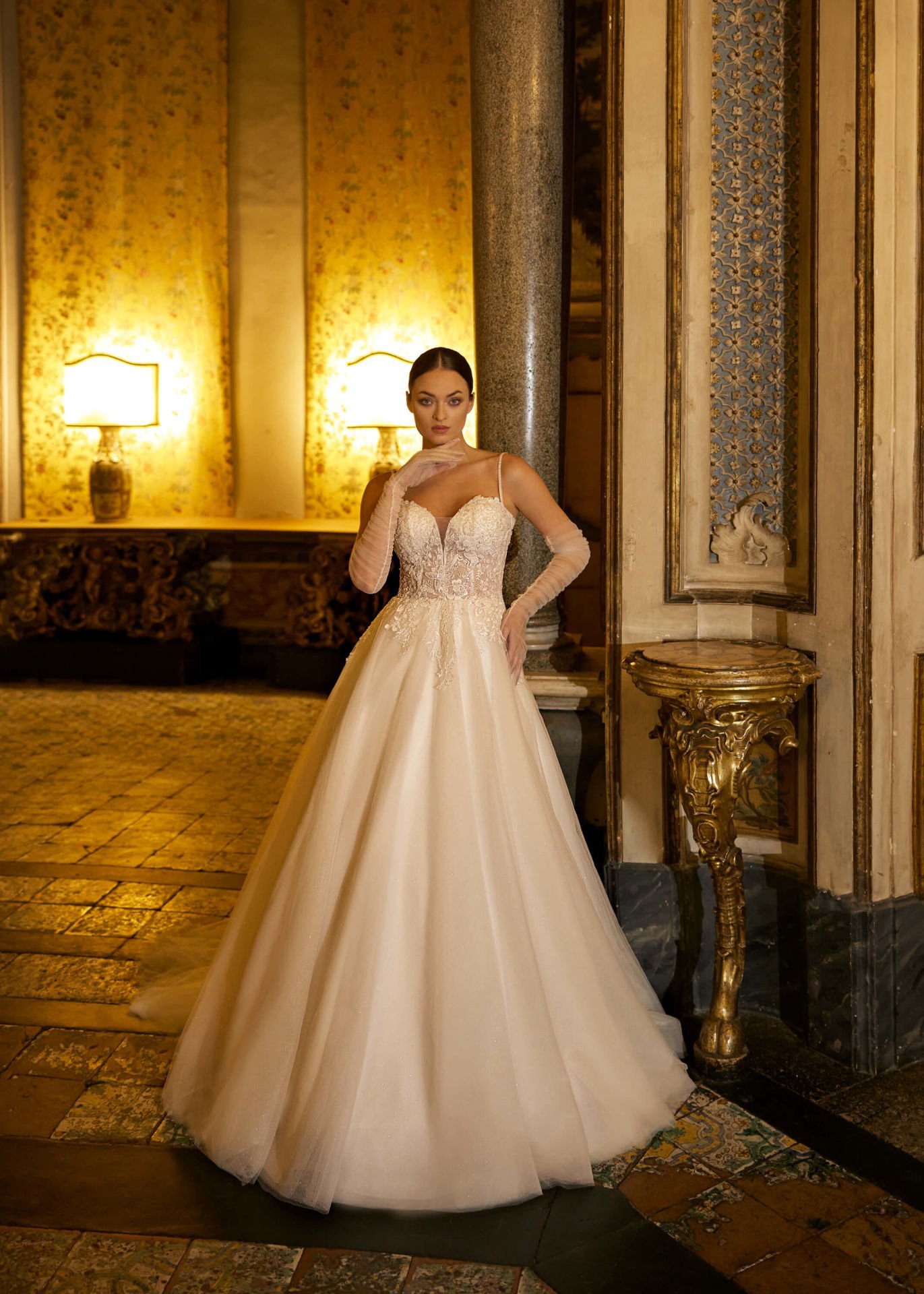 A-cut wedding dress model with sweetheart neckline, crystal embroidered lace, thin spaghetti straps, semi-transparent appearance