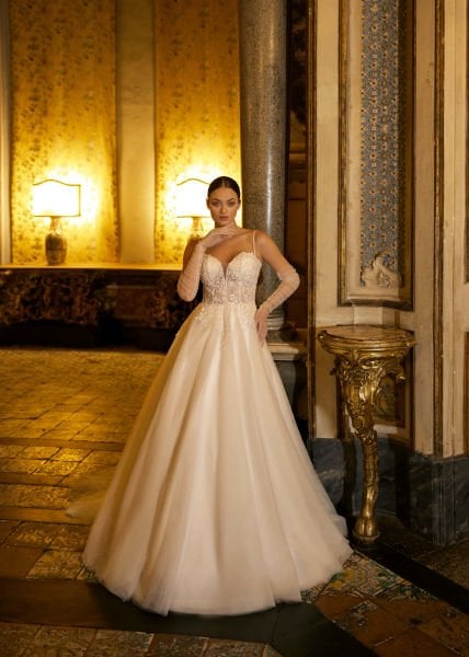A-cut wedding dress model with sweetheart neckline, crystal embroidered lace, thin spaghetti straps, semi-transparent appearance