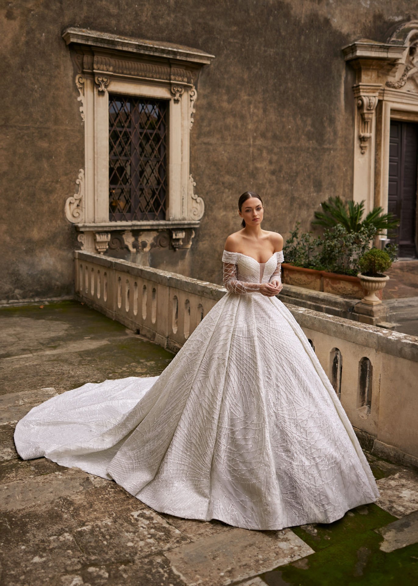 Princess cut wedding dress model with special bead embroidery on tulle, madonna neckline and tail