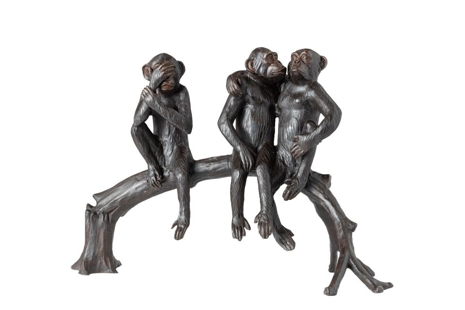 TREE MONKEYS SITTING ON A TREE STUMP