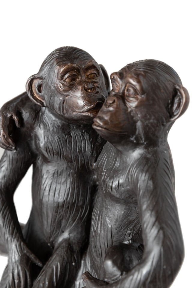 TREE MONKEYS SITTING ON A TREE STUMP