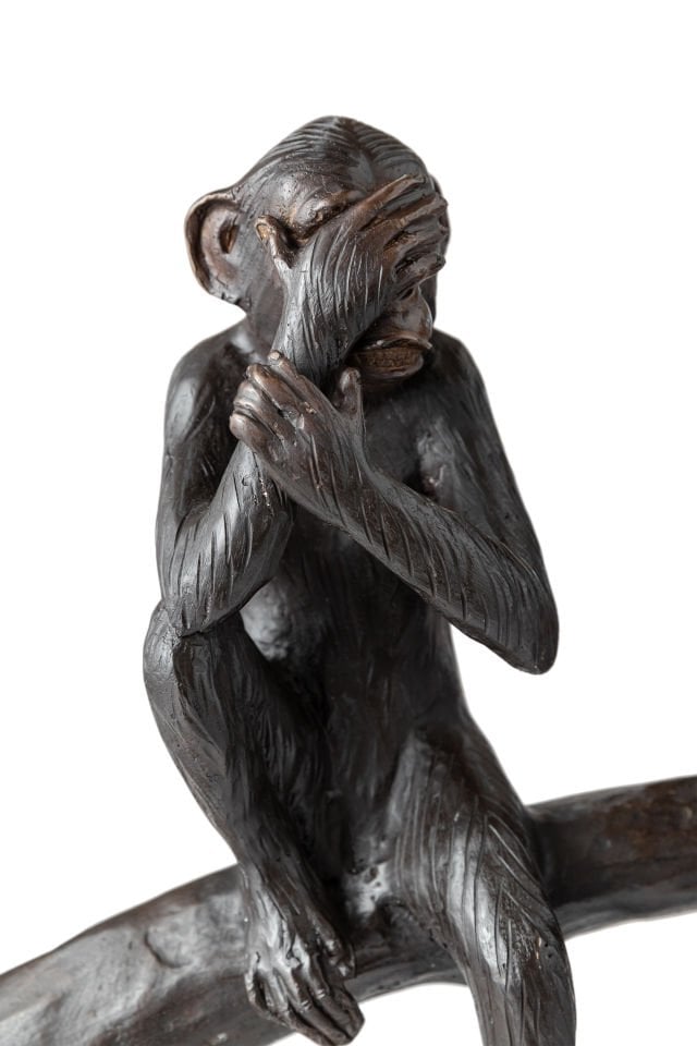 TREE MONKEYS SITTING ON A TREE STUMP