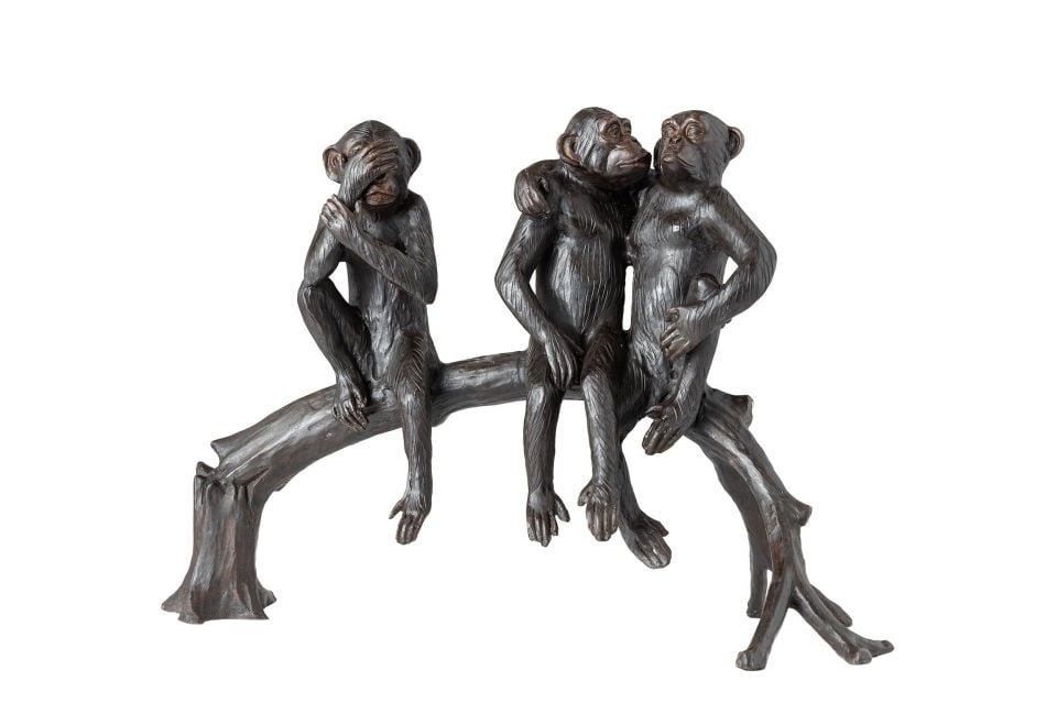 TREE MONKEYS SITTING ON A TREE STUMP