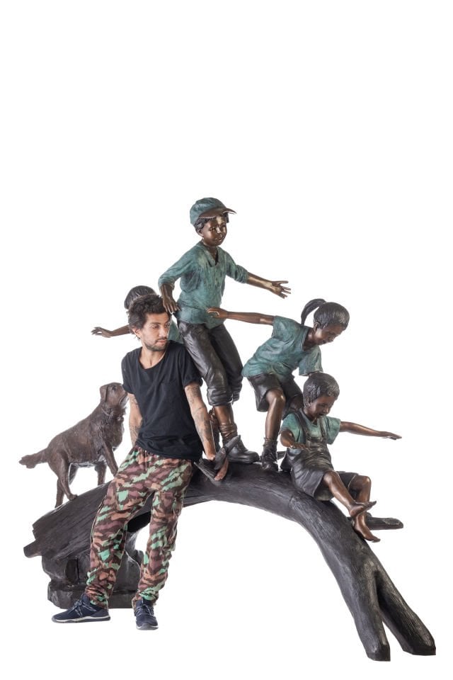 CHILDREN PLAYING ON A TREE STUMP
