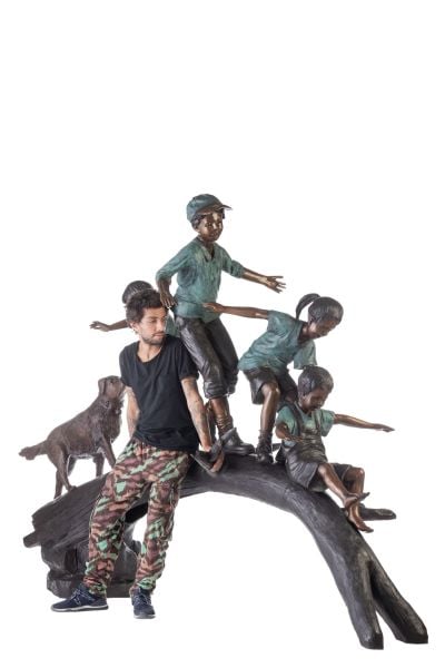 CHILDREN PLAYING ON A TREE STUMP